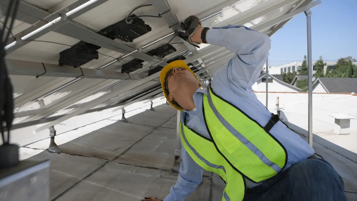 Maintenance worker adjusting solar panels