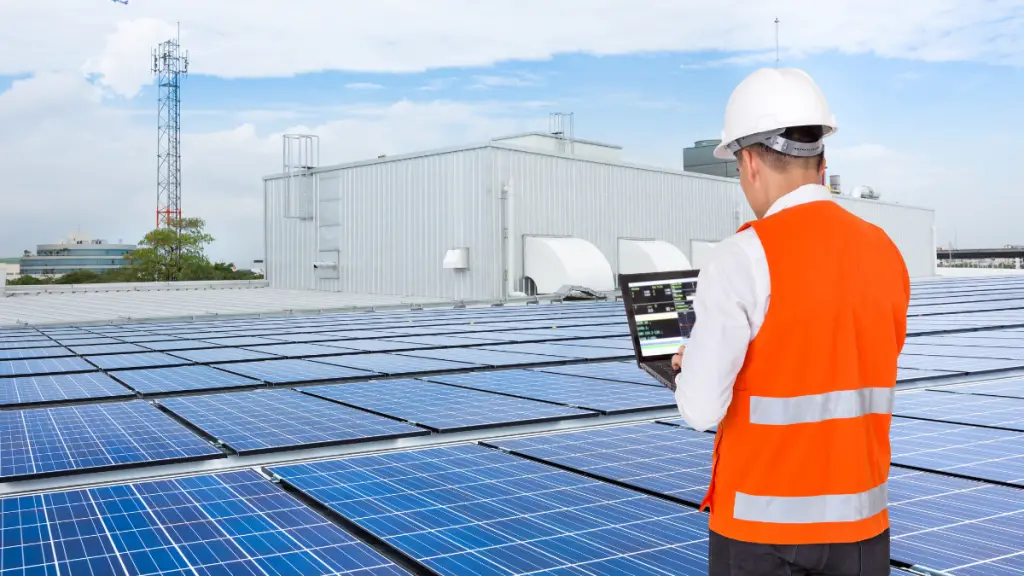Engineer standing by solar panels
