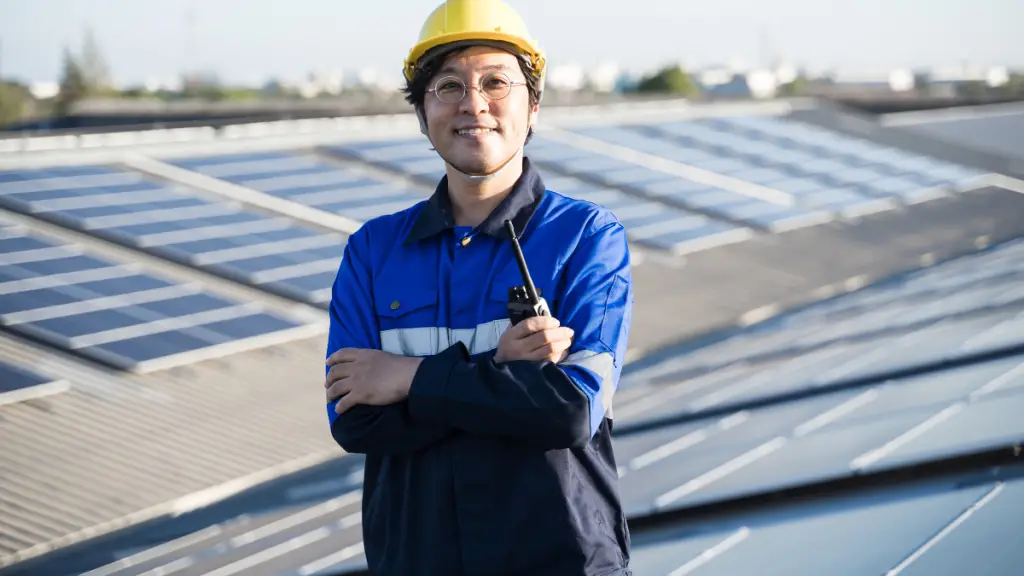 Man standing by solar panels
