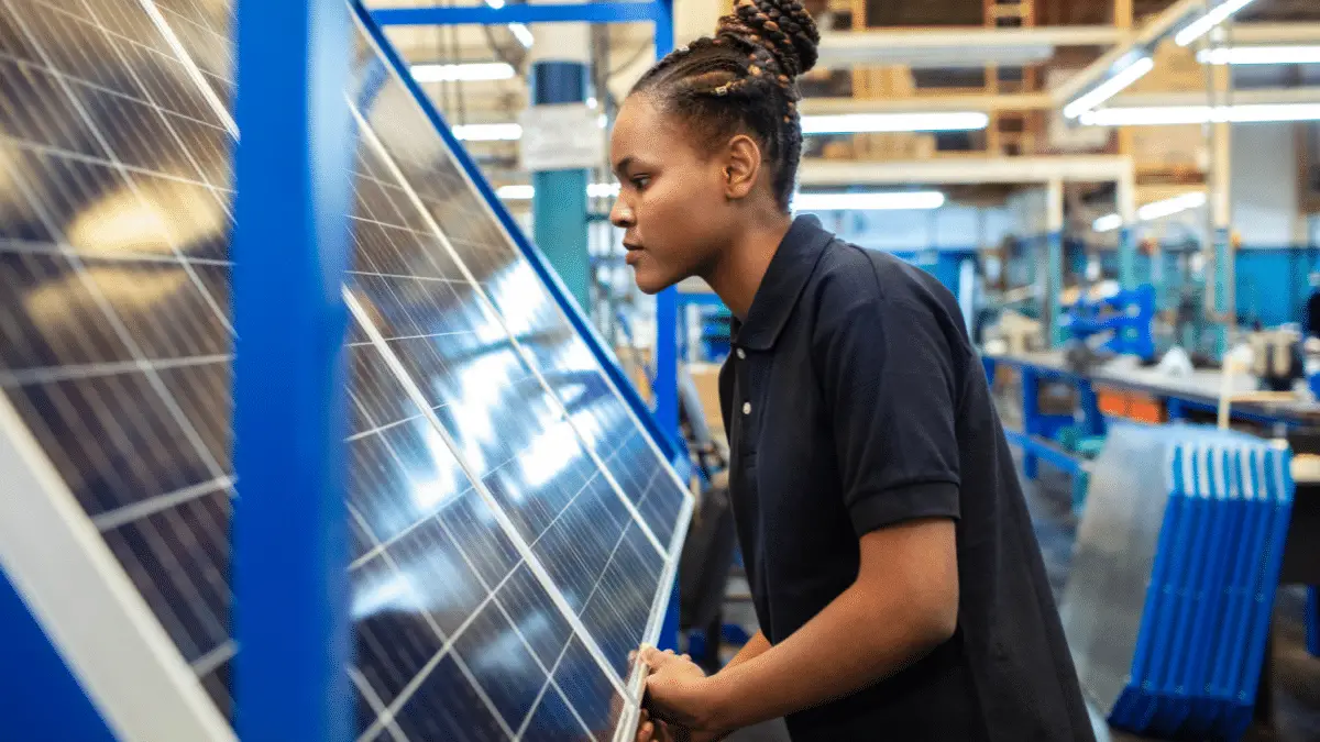 Quality engineer examining high quality solar panels in factory
