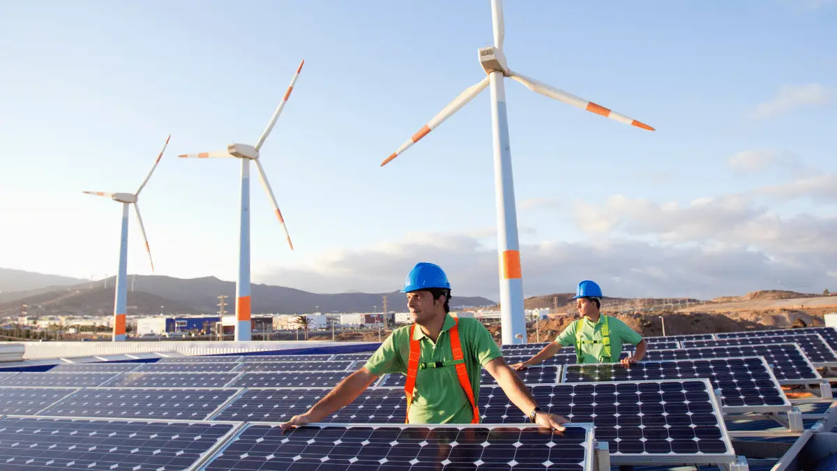 Engineers installing solar panels and wind turbines