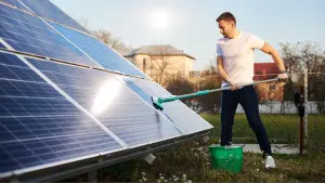 solar installer cleaning PV arrays